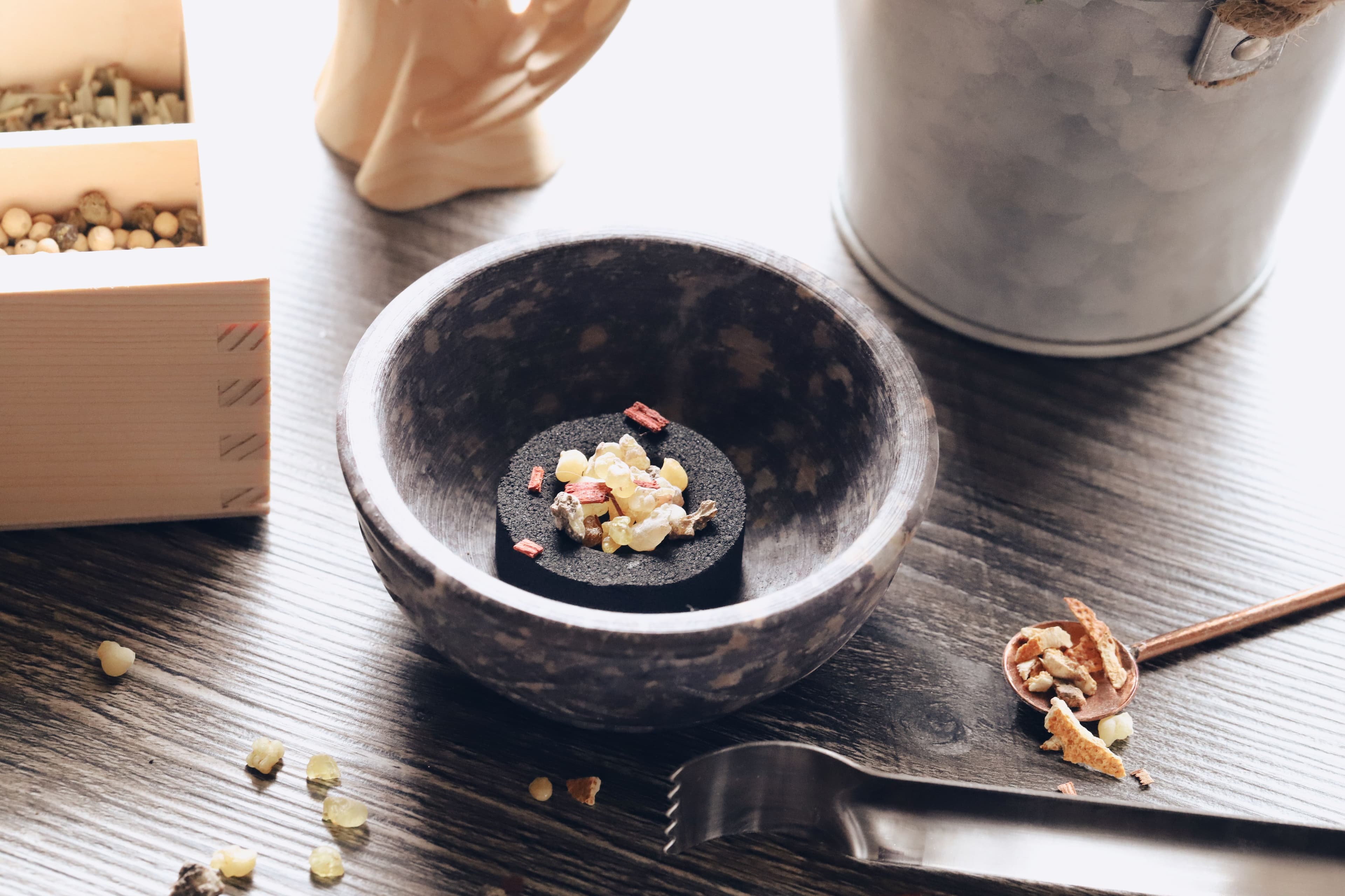 Myrrh tears in a stone bowl, sorted and ready for packaging.